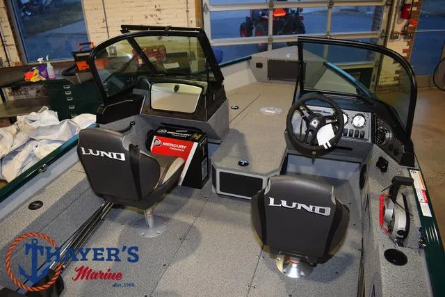 Slide: The Image of 2025 Lund 1675 Adventure Sport boat interior with dual seats and steering console. - 34