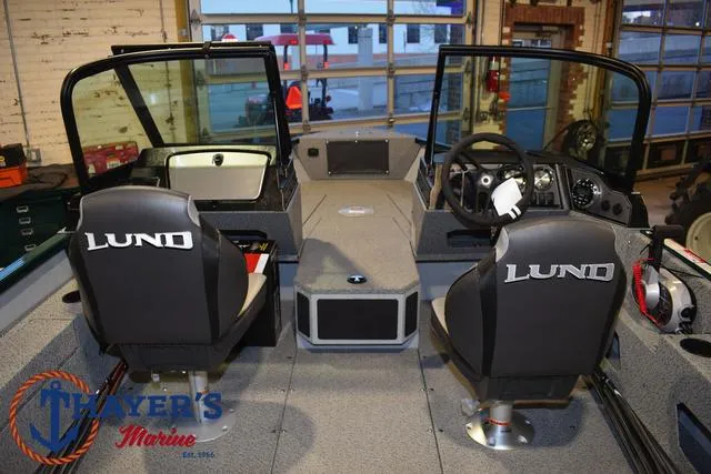Slide: The Image of 2025 Lund 1675 Adventure Sport boat interior with dual seats and steering console. - 35