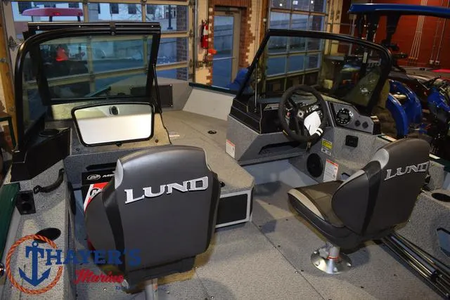 Slide: The Image of 2025 Lund 1675 Adventure Sport boat interior with steering console and seating. - 36
