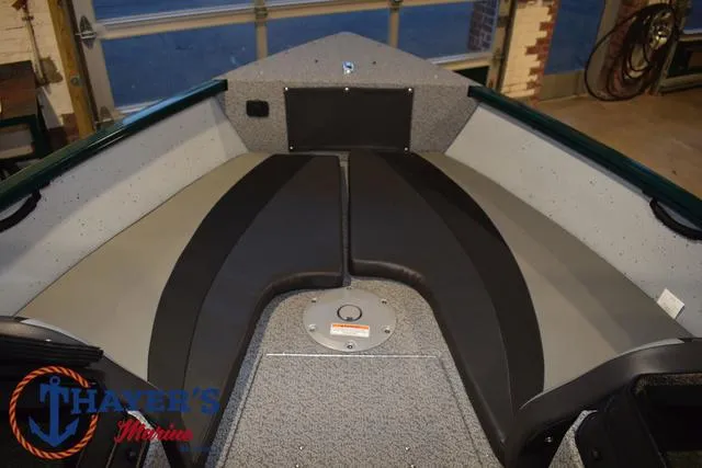 Slide: The Image of 2025 Lund 1675 Adventure Sport boat interior with cushioned seating and carpeted flooring. - 41