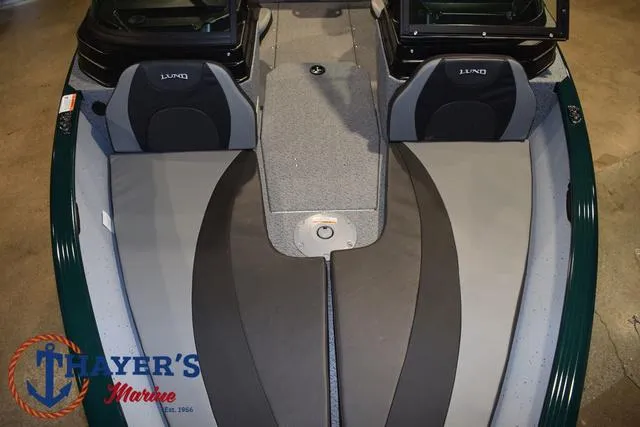 Slide: The Image of 2025 Lund 1675 Adventure Sport boat interior with seating and Thayer's Marine logo. - 42