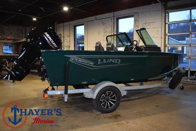 Slide: The Image of 2025 Lund 1675 Adventure Sport boat on trailer at Thayer's Marine showroom. - 44