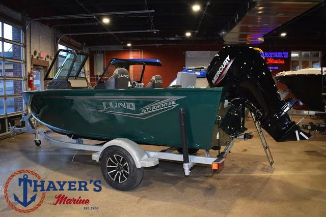 Slide: The Image of 2025 Lund 1675 Adventure Sport boat on trailer at Thayer's Marine showroom. - 8