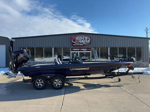 Slide: The Image of 2025 Phoenix 721zxl boat parked outside Rhea's Marine dealership. - 1