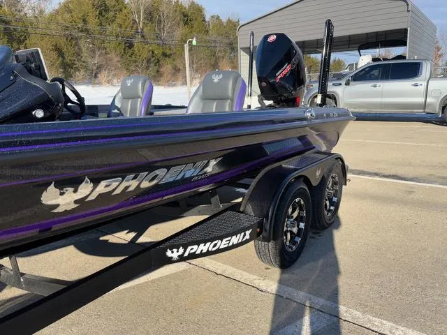 Slide: The Image of 2025 Phoenix 721zxl boat on trailer, parked outdoors, showcasing sleek design and branding. - 13