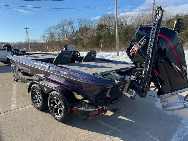 Slide: The Image of 2025 Phoenix 721zxl bass boat with powerful outboard motor, parked on a sunny day. - 16