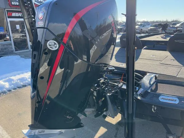 Slide: The Image of 2025 Phoenix 721zxl boat motor with red accents, parked outdoors on a sunny day. - 3