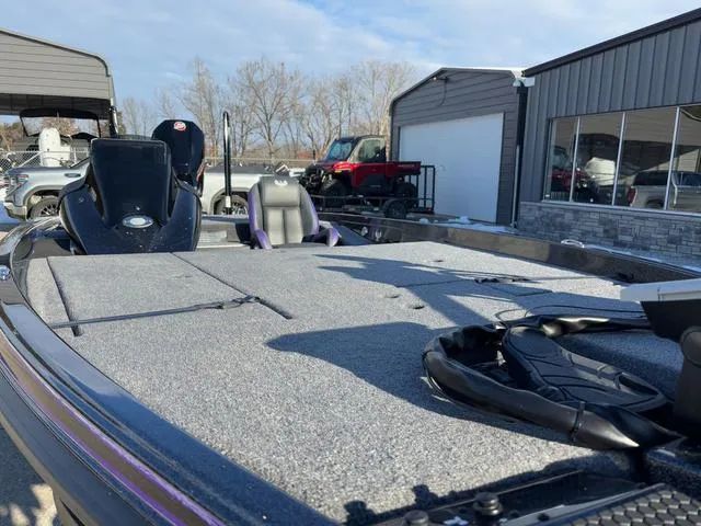 Slide: The Image of 2025 Phoenix 721zxl boat with spacious deck, parked near a garage. - 8