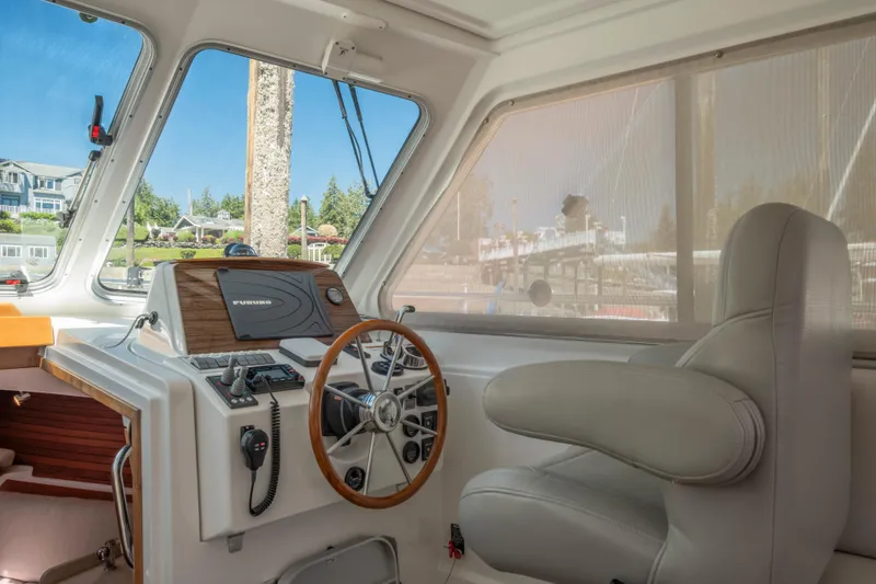 Slide: The Image of Interior of 2016 Back Cove 30 boat with steering wheel and navigation controls. - 13