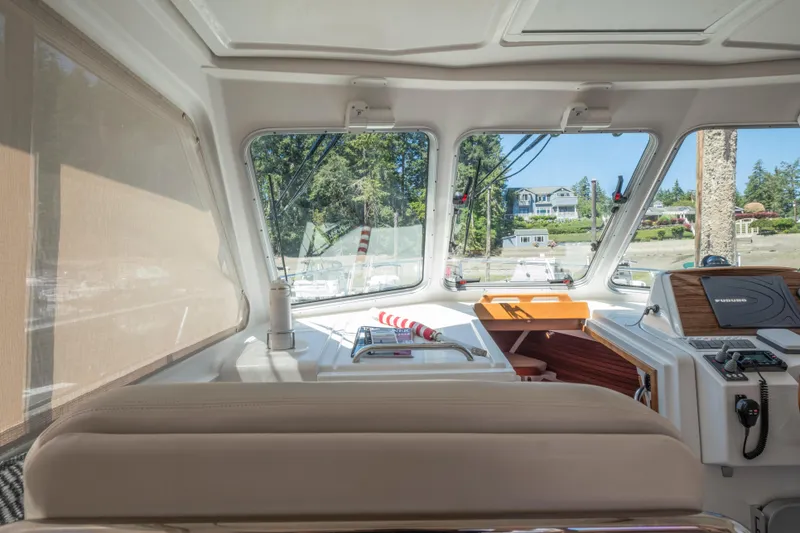 Slide: The Image of Interior view of 2016 Back Cove 30 boat, featuring helm and seating area. - 17