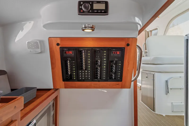 Slide: The Image of Electrical panel inside 2016 Back Cove 30 boat, featuring modern controls and wood accents. - 21