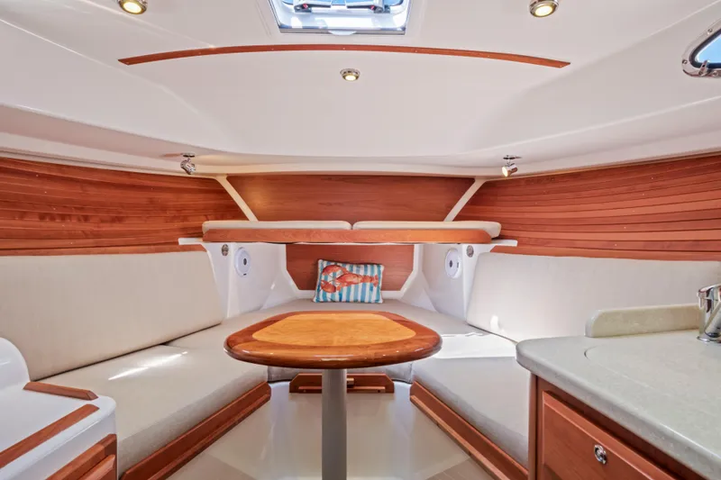 Slide: The Image of 2016 Back Cove 30 interior with wood accents and cozy seating area. - 26