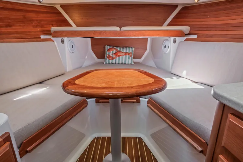 Slide: The Image of Cozy interior of 2016 Back Cove 30 boat with wooden accents and cushioned seating. - 28