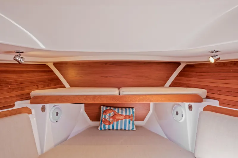 Slide: The Image of Interior of 2016 Back Cove 30 boat with wood paneling and nautical-themed pillow. - 29
