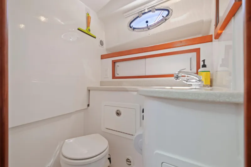 Slide: The Image of 2016 Back Cove 30 yacht bathroom with modern fixtures and porthole window. - 30