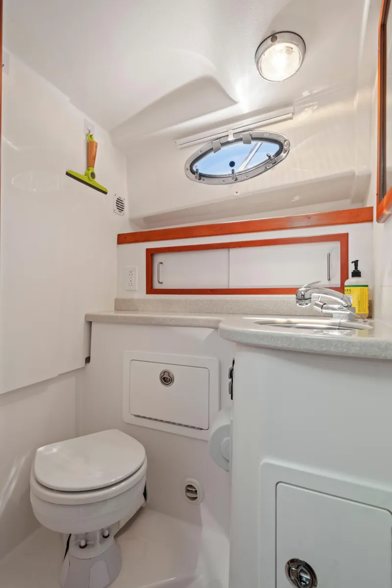 Slide: The Image of 2016 Back Cove 30 yacht bathroom with modern fixtures and porthole window. - 31