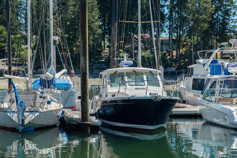 Slide: The Image of 2016 Back Cove 30 boat docked among sailboats in a marina. - 41