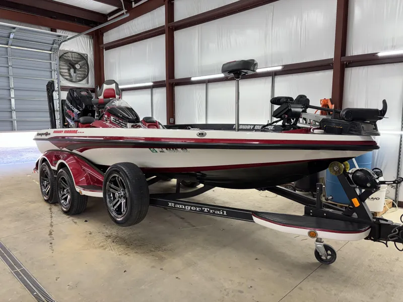 Slide: The Image of 2018 Ranger Z518c bass boat in a garage, featuring a sleek red and white design. - 31