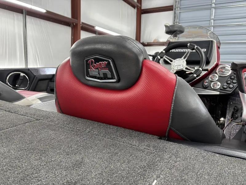 Slide: The Image of 2018 Ranger Z518c boat interior with red and black seats, steering wheel, and dashboard controls. - 36