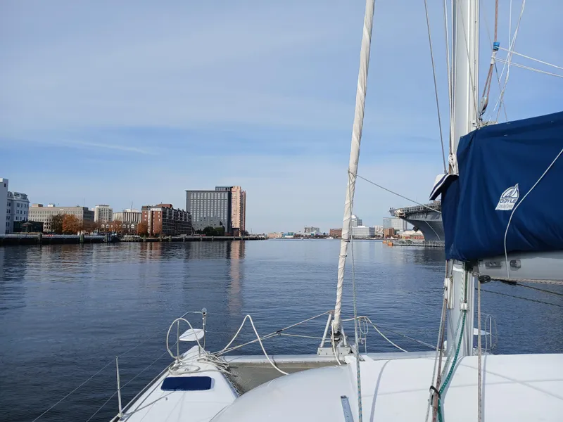 Slide: The Image of Sailing on a 2007 Lagoon 380 S2 catamaran in a calm urban harbor. - 11