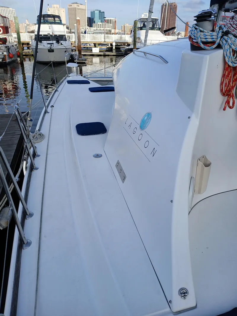 Slide: The Image of 2007 Lagoon 380 S2 catamaran docked at marina with city skyline. - 14