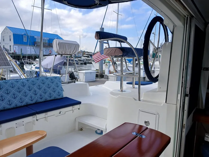 Slide: The Image of 2007 Lagoon 380 S2 catamaran interior with blue seating, docked at marina. - 16