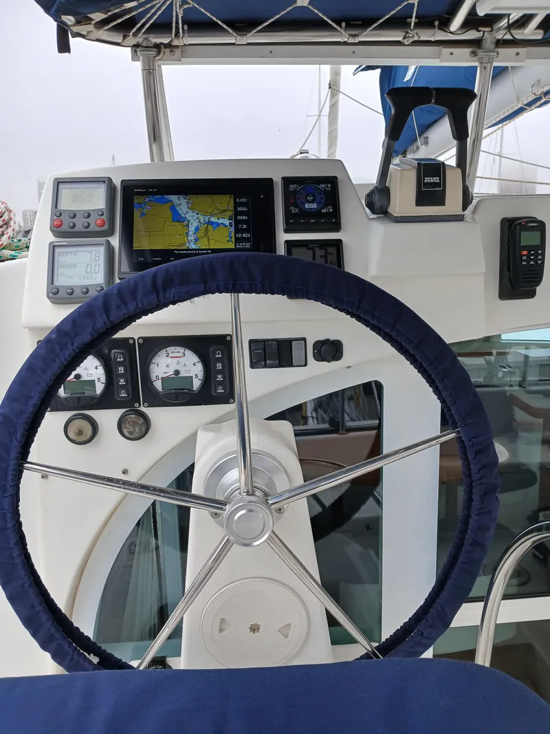 Slide: The Image of Steering wheel and navigation controls of a 2007 Lagoon 380 S2 catamaran. - 18