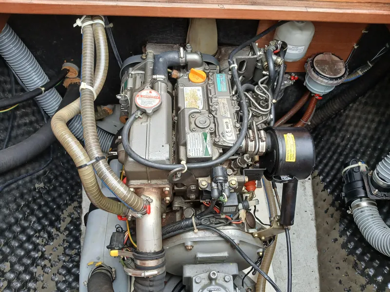 Slide: The Image of Engine compartment of a 2007 Lagoon 380 S2 catamaran, showcasing detailed mechanical components. - 22