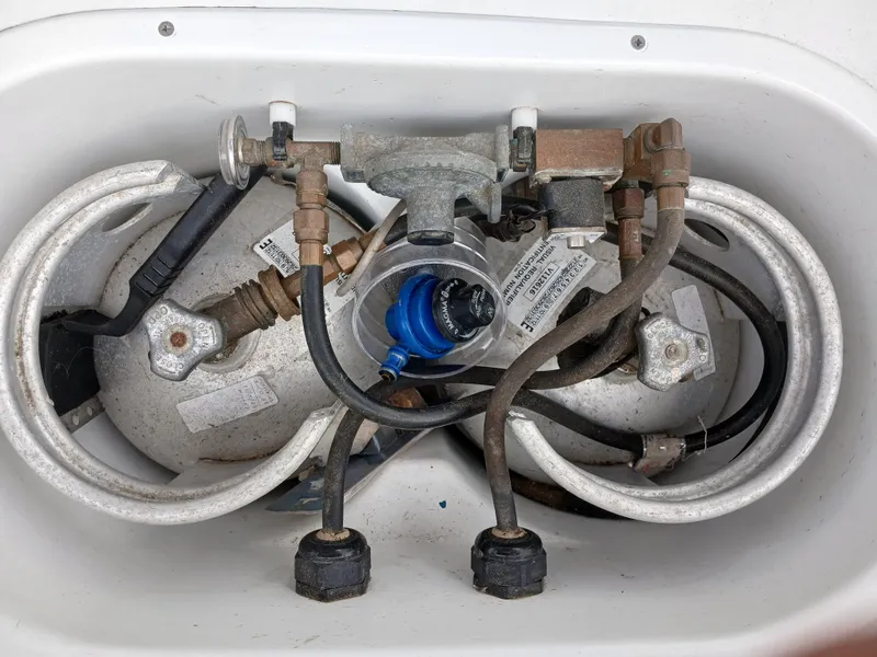 Slide: The Image of Two propane tanks with hoses and connectors in a Lagoon 380 S2, 2007 model. - 24