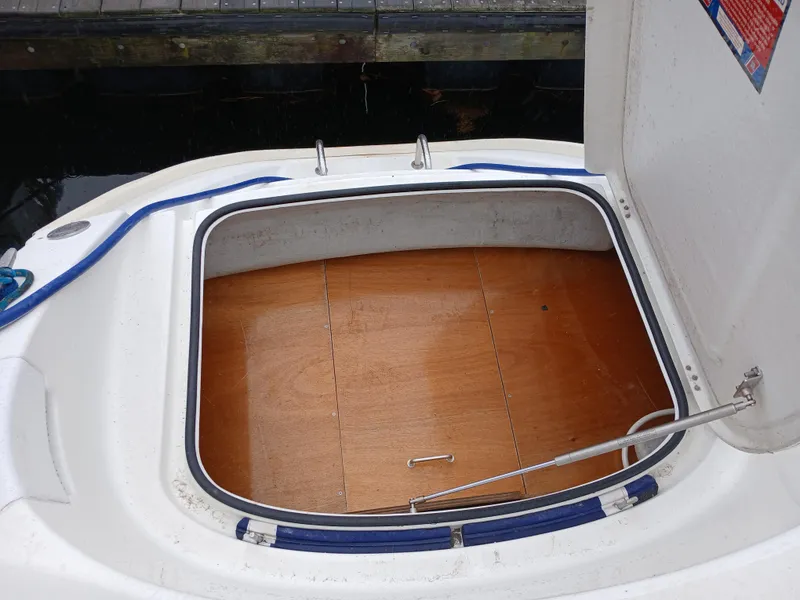 Slide: The Image of Open storage compartment on 2007 Lagoon 380 S2 boat, featuring wooden flooring. - 27