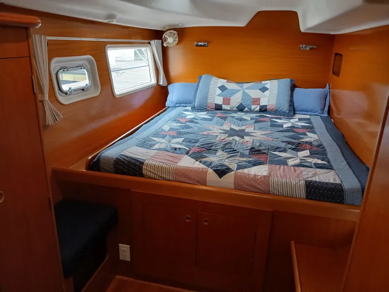 Slide: The Image of Cozy cabin interior of 2007 Lagoon 380 S2 with quilted bedspread and wooden finish. - 30
