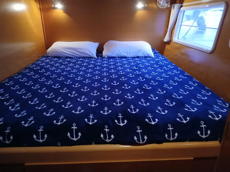 Slide: The Image of Cozy cabin bed with anchor-patterned bedding in 2007 Lagoon 380 S2 yacht. - 36