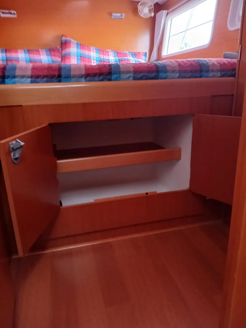 Slide: The Image of 2007 Lagoon 380 S2 cabin with bed, storage, and wooden interior. - 39