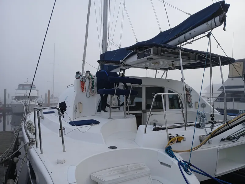 Slide: The Image of 2007 Lagoon 380 S2 catamaran docked in a foggy marina. - 4