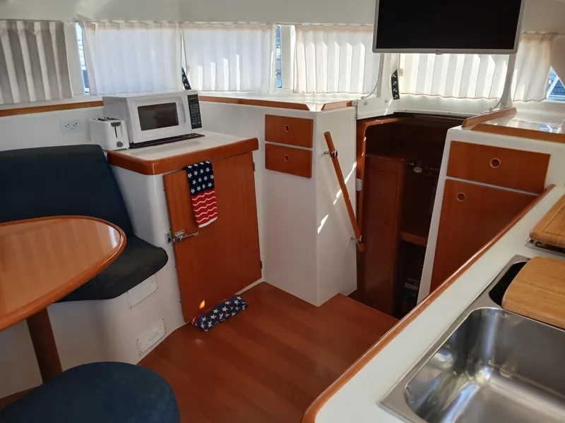 Slide: The Image of Interior of 2007 Lagoon 380 S2 yacht with kitchen and seating area. - 43