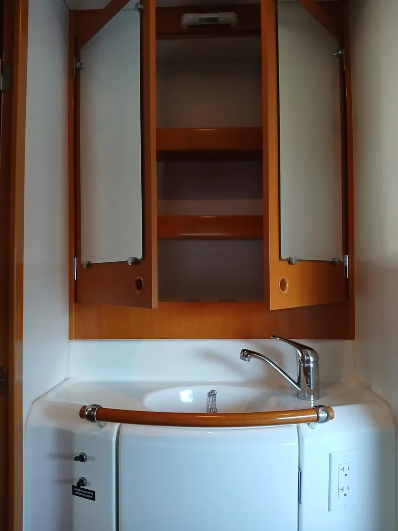 Slide: The Image of Wooden cabinet and sink in 2007 Lagoon 380 S2 yacht bathroom. - 44