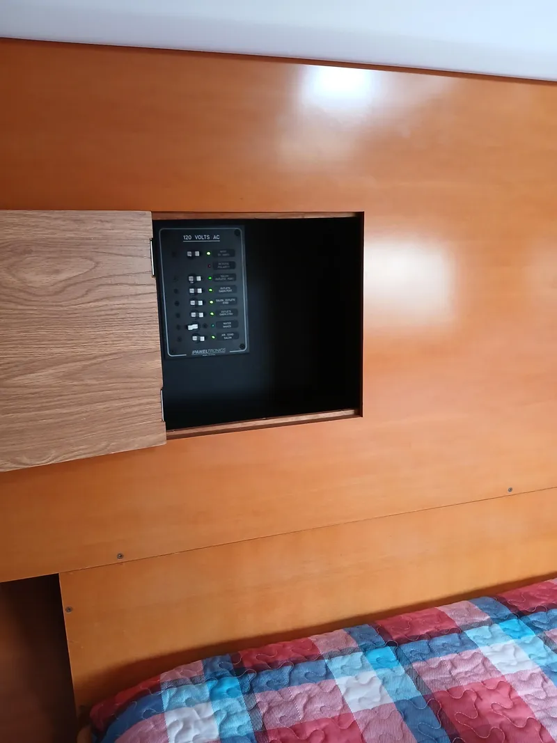 Slide: The Image of Wooden interior panel with an open compartment on a 2007 Lagoon 380 S2 yacht. - 45