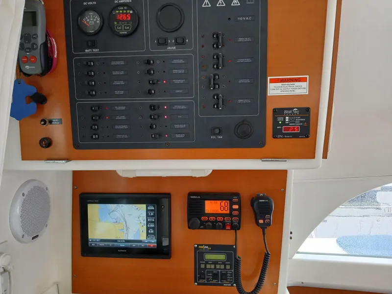 Slide: The Image of Control panel of a 2007 Lagoon 380 S2 catamaran with navigation and communication equipment. - 46