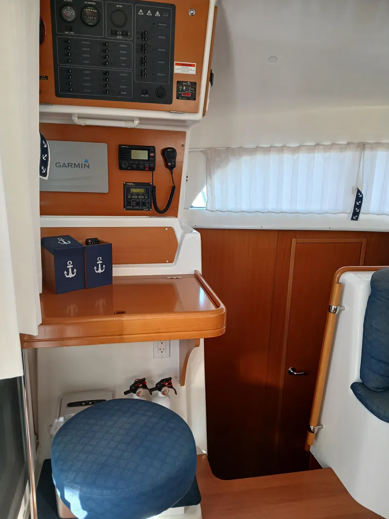 Slide: The Image of Interior of 2007 Lagoon 380 S2 yacht with navigation equipment and seating area. - 47