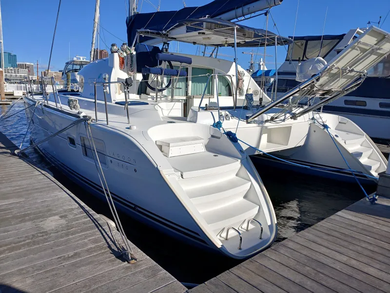 Slide: The Image of 2007 Lagoon 380 S2 catamaran docked at marina under clear blue sky. - 7
