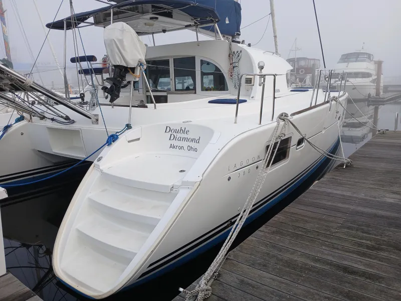 Slide: The Image of 2007 Lagoon 380 S2 catamaran docked, named "Double Diamond," with visible stern and boarding steps. - 9