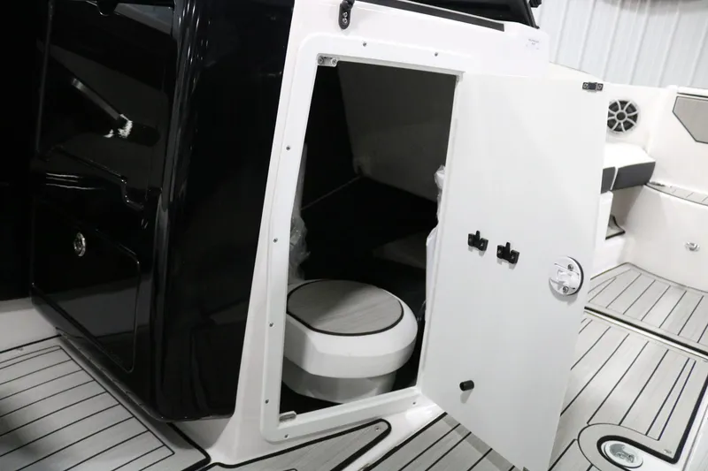 Slide: The Image of 2025 Yamaha Boats 222S interior with open storage compartment and seating area. - 10