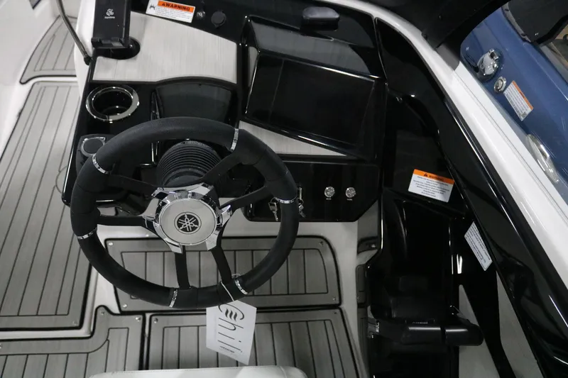 Slide: The Image of 2025 Yamaha Boats 222S steering wheel and dashboard interior. - 15