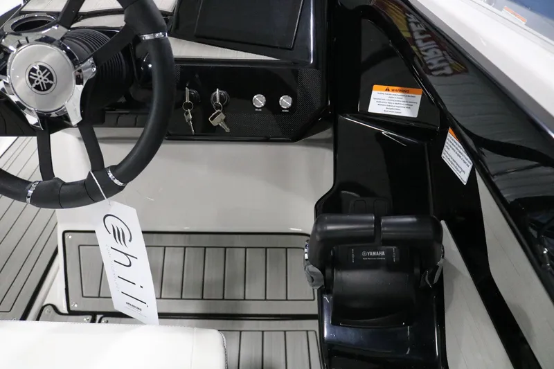 Slide: The Image of 2025 Yamaha Boats 222S steering wheel and control panel close-up. - 17