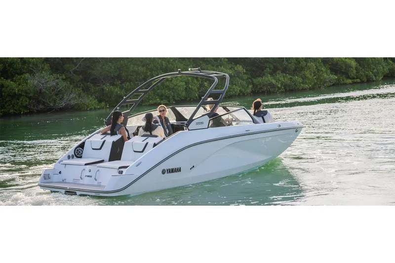 Slide: The Image of 2025 Yamaha Boats 222S cruising on a serene waterway with passengers. - 40
