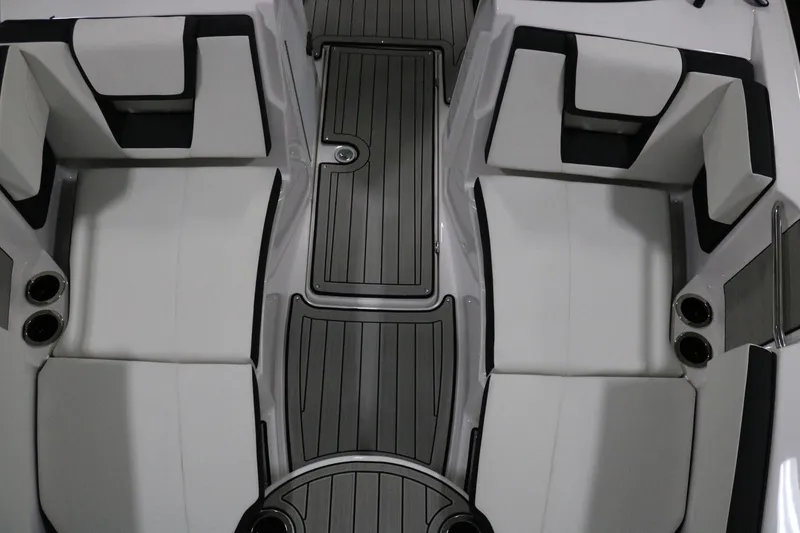 Slide: The Image of 2025 Yamaha Boats 222S interior seating with sleek design and cup holders. - 6