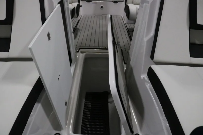 Slide: The Image of 2025 Yamaha Boats 222S interior storage compartment with open hatch, showcasing sleek design. - 9