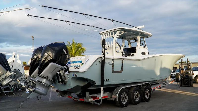 Slide: The Image of 2023 Tidewater 320 CC Adventure boat on trailer, ready for transport. - 2