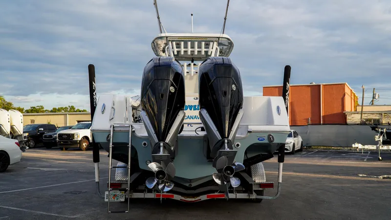 Slide: The Image of 2023 Tidewater 320 CC Adventure boat with dual engines in a parking lot. - 3