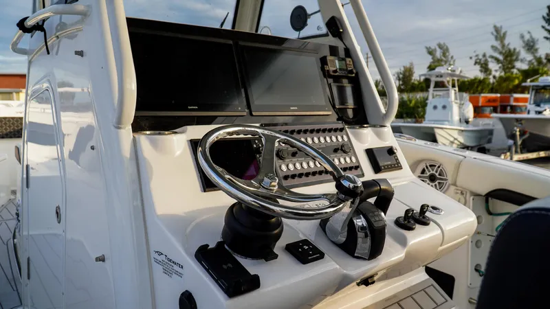 Slide: The Image of 2023 Tidewater 320 CC Adventure boat helm with modern controls and dual screens. - 5